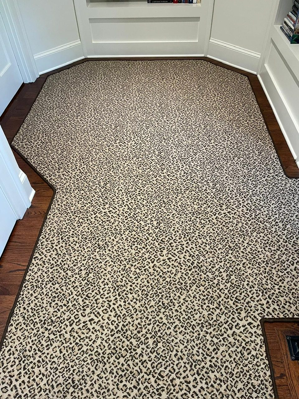 Leopard-print carpet custom-cut and bound to fit an alcove