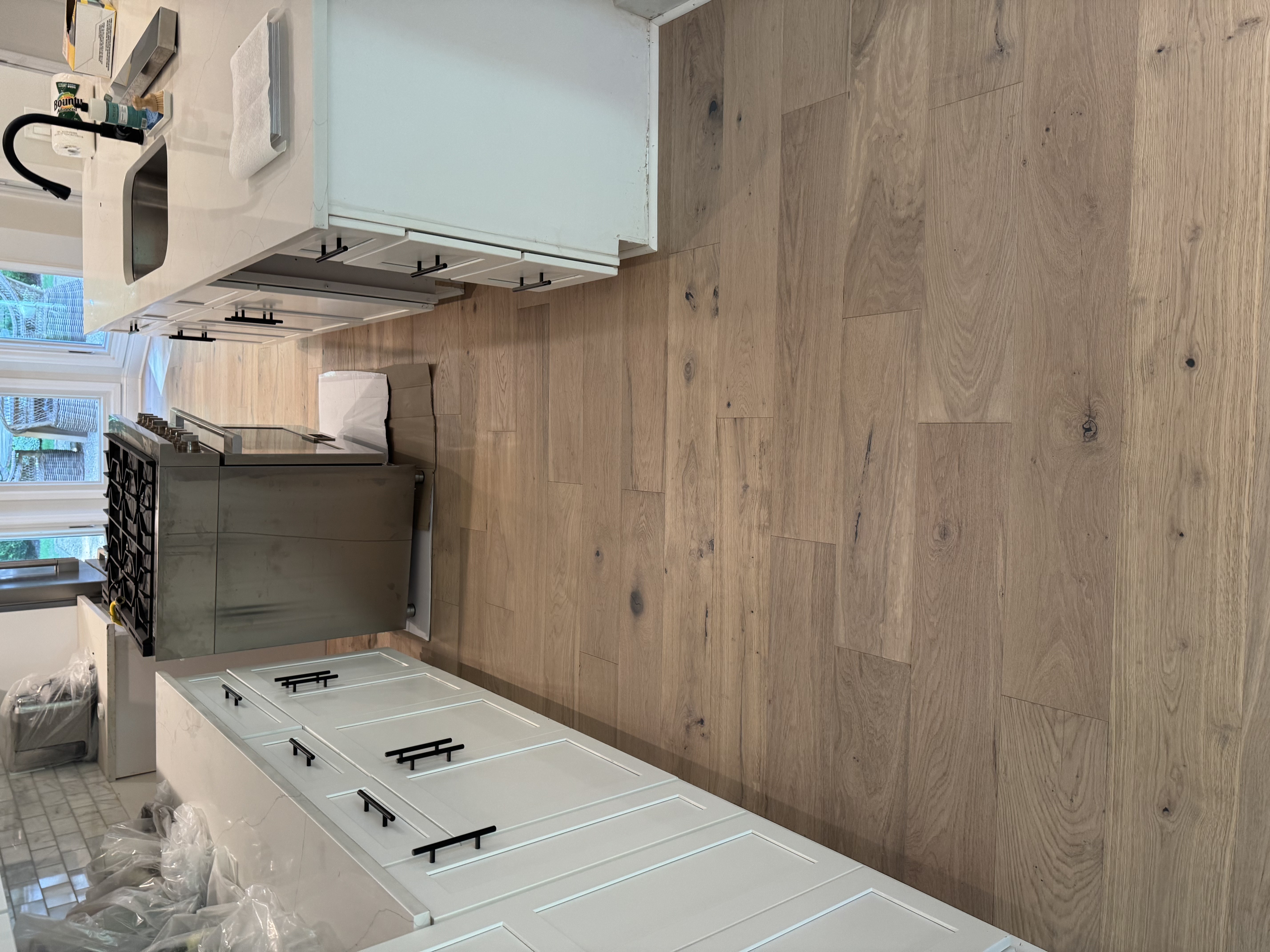 Light oak wide-plank hardwood floor in kitchen