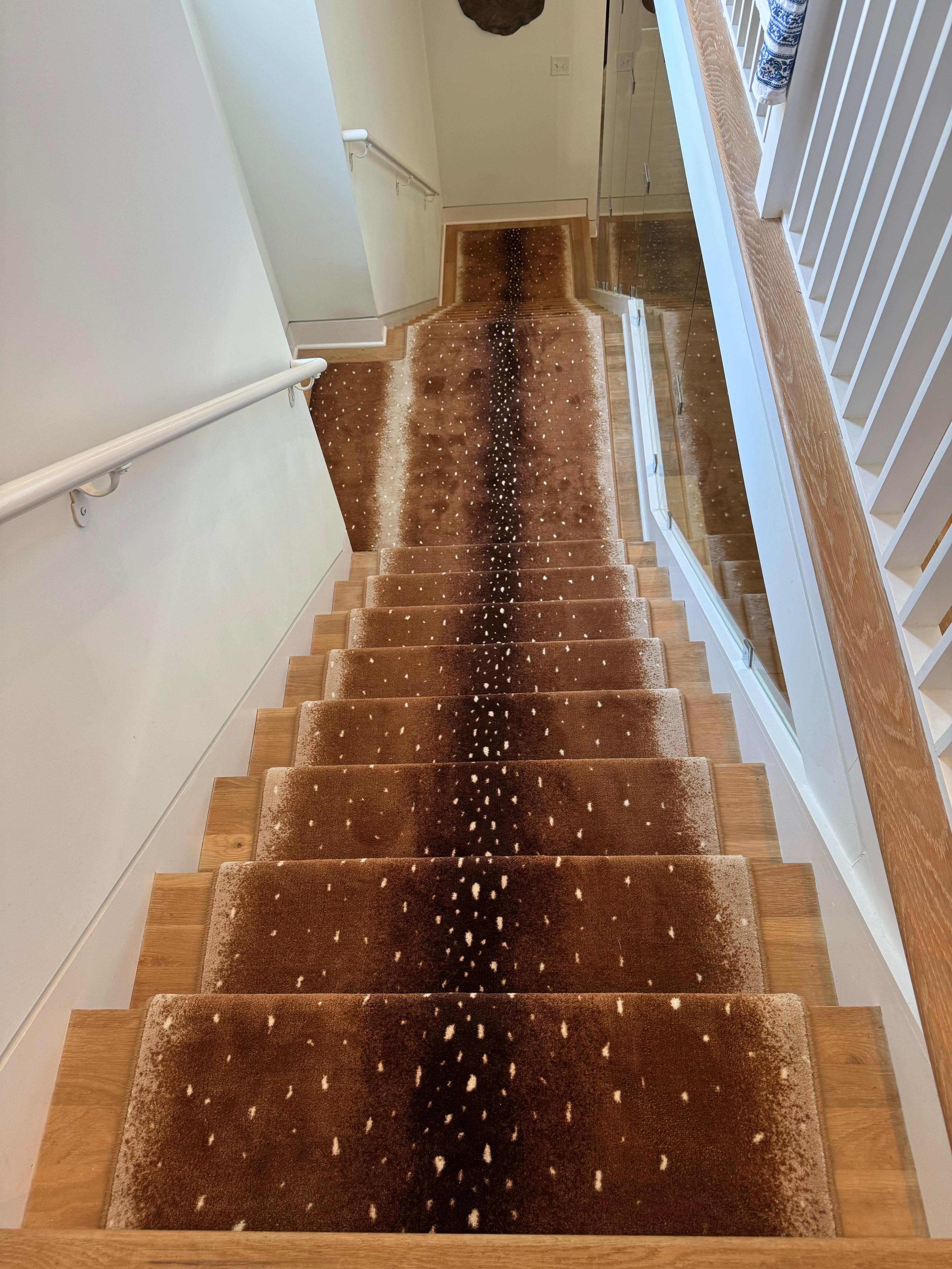 Faux deer hide stair runner on straight staircase