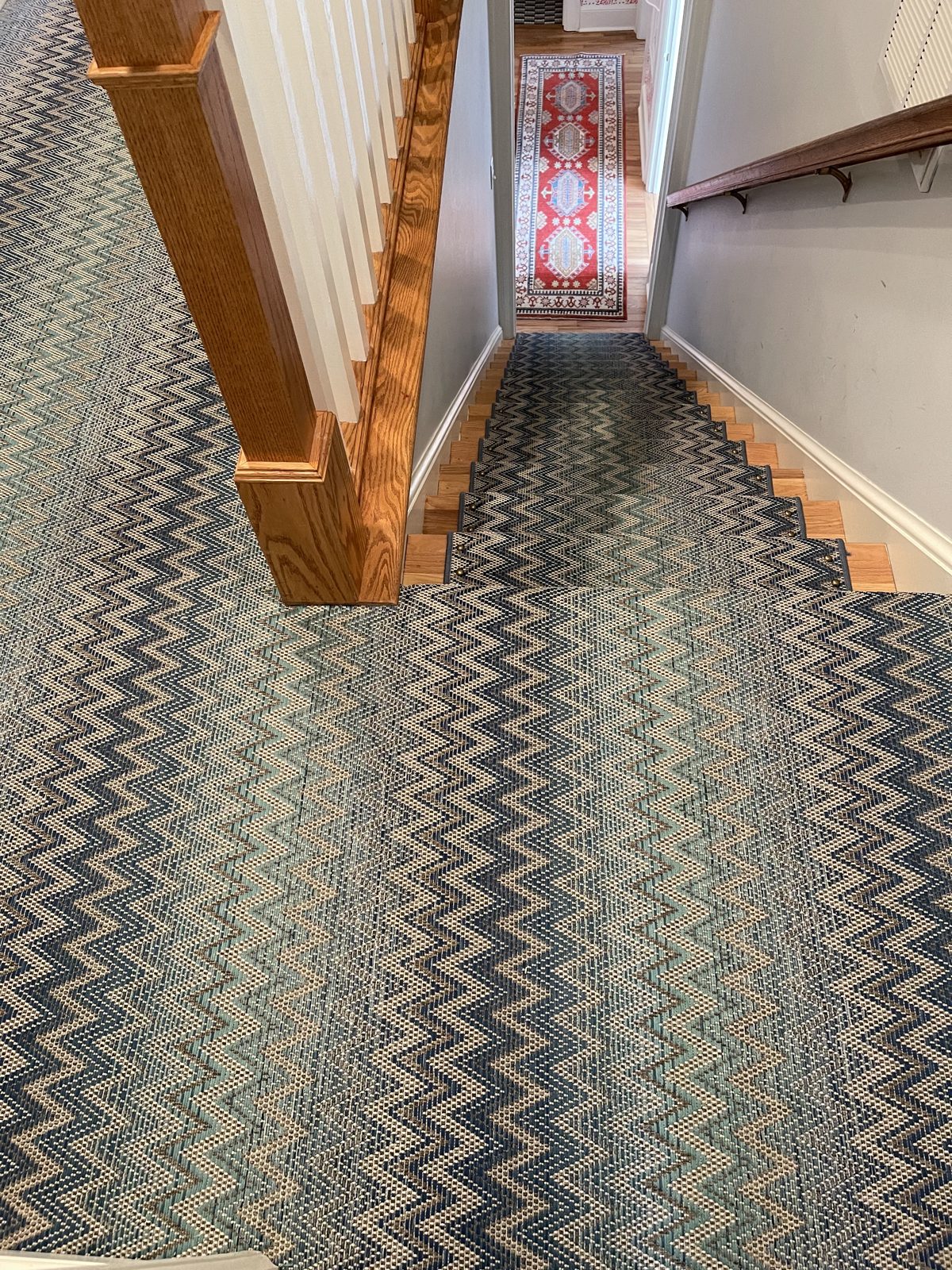 Blue and cream chevron stair runner flowing down to a landing