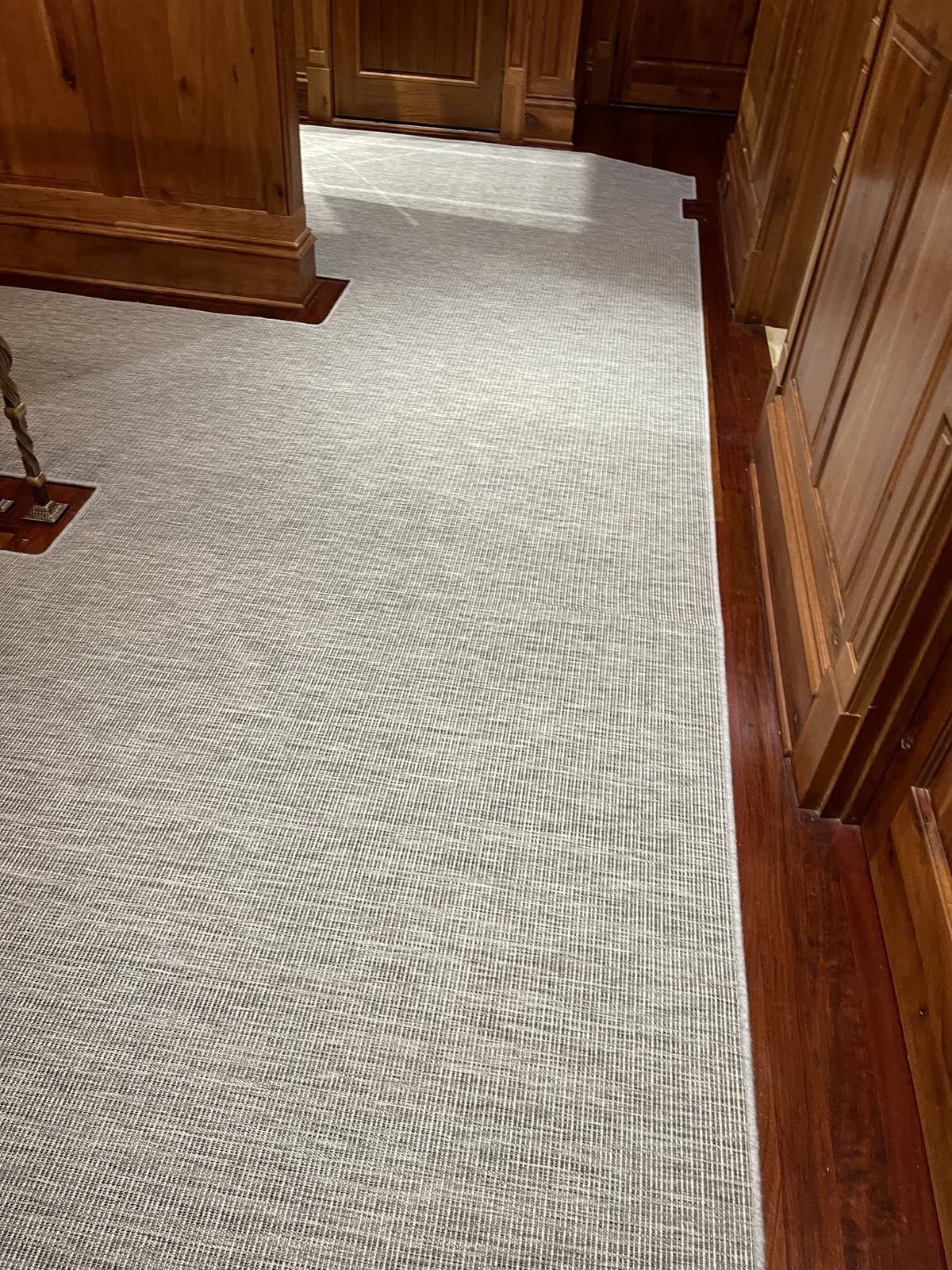 Soft neutral hallway runner with binding on hardwood