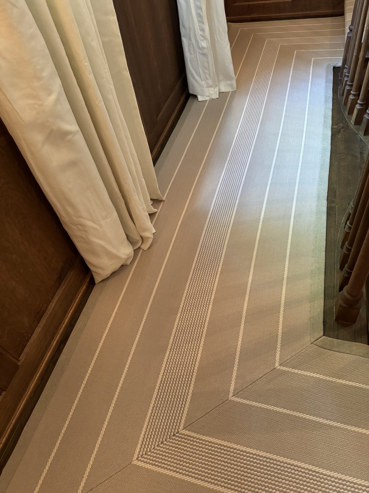 Patterned hallway runner with a decorative bound border