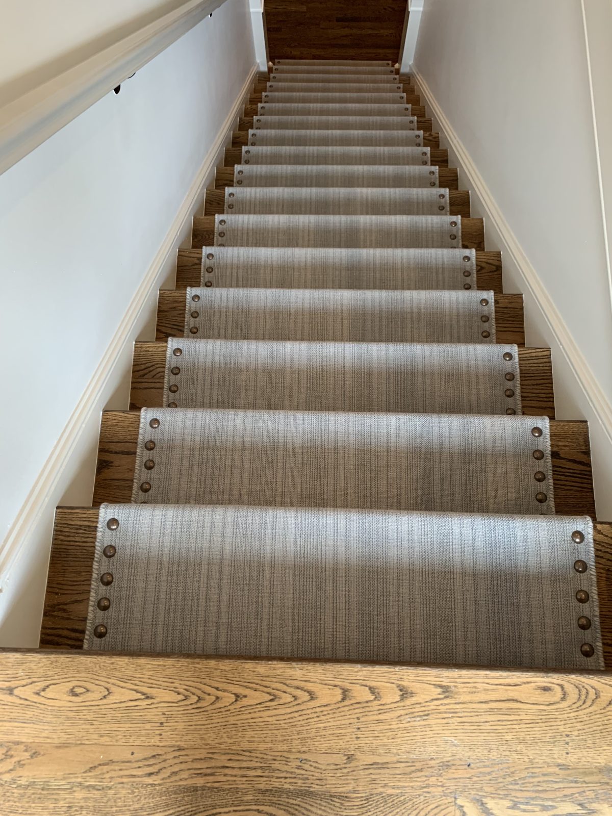 Gray striped stair runner on a straight staircase