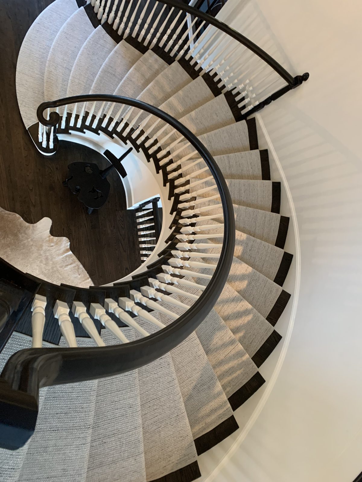Dramatic spiral staircase stair runner viewed from above