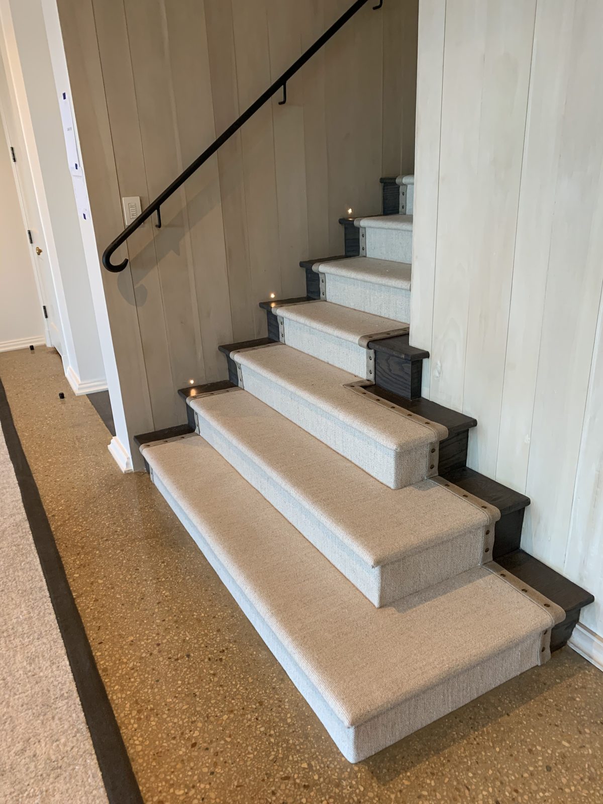Neutral sisal stair runner on a wide staircase