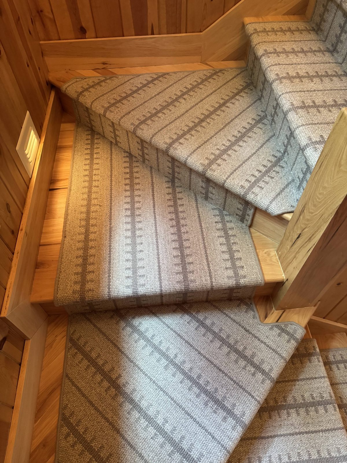 Neutral stair runner on a multi-flight staircase from above