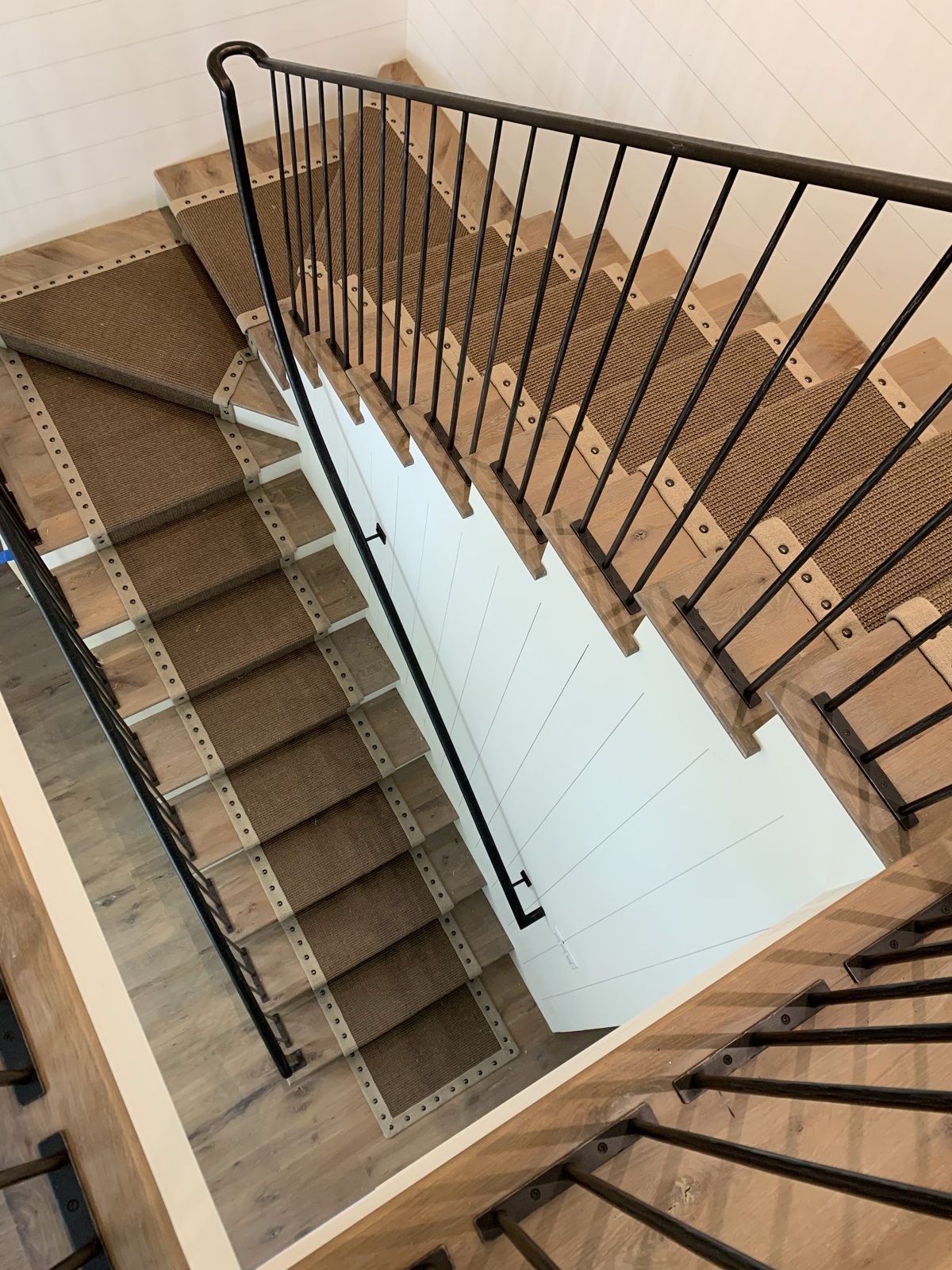 Stair runner on a staircase with a glass railing