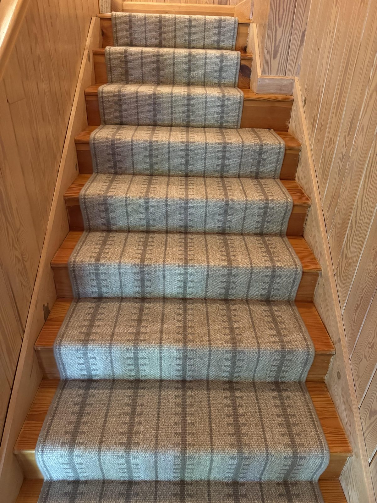 Blue ticking-stripe stair runner on a straight staircase